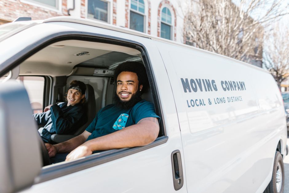 Smiling professional movers team in uniform
